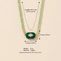 Green beaded necklace with emerald-style evil eye copper pendant and zircon inlay - Green