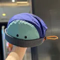 Close-up of a retro color-block 5-panel docker cap with adjustable orange toggle strap. - Adjustable / Navy Blue - Brimless Hat