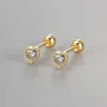 Close-up detail of gold heart stud earrings with cubic zirconia and screw ball back - Gold / White