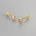 Detailed macro view of gold heart stud earrings with pink zircon and screw ball back - Gold / Pink
