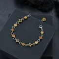 Professional luxury zircon bracelet with colorful stones on black gift box background - Cross Zirconia Bracelet Antique Gold (S739-B)