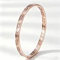 Elegant rose gold titanium steel bangle with hollow Greek key pattern design. - Check Pattern / Rose Gold