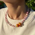 Detail shot of pink beaded choker necklace with yellow lampwork glass pendant on model - Natural Stone Lampwork Flower Necklace / 38+5cm