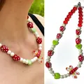 Detailed view of beaded necklace with red glass strawberry and lobster pendant - Strawberry Heart Dragonfly Necklace / 38+5cm