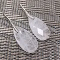 Detailed macro view of faceted clear crystal teardrop earrings with elegant silver hooks. - 13*25*6MM / White Crystal