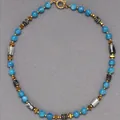 Close-up detail of natural blue stone beaded necklace with gold geometric spacers. - Necklace 11 (38+5cm)