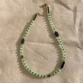 Detail view of natural stone beaded necklace with green, blue, and black beads on fabric - Necklace 14 (38+5cm)