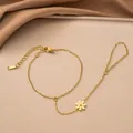 Detail of gold-plated stainless steel hand chain featuring a small flower charm - Daisy Hand Chain Bracelet / 10mm / Gold