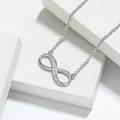 Macro view of sterling silver infinity pendant necklace with sparkling zircon details - Necklace / White Gold