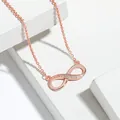 Detailed view of a rose gold infinity symbol necklace set with sparkling white stones - Necklace / Rose Gold