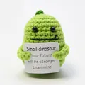 Small green handmade crochet dinosaur doll holding a positive message card - Green Dinosaur