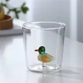 Detailed view of 3D glass duck figurine inside a clear glass drinking cup - Duck
