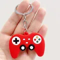 Close-up of red soft rubber game controller keychain with colorful buttons details - Simulation Gamepad / Red