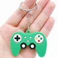 Close-up of a green game controller keychain made of soft rubber held in hand - Simulation Gamepad / Green
