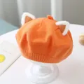 Detailed macro view of an orange knitted baby beret featuring cute plush animal ears. - One Size 46-51cm / Orange