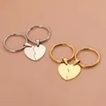Close-up of split heart-shaped couple keychains in silver and gold stainless steel - Key Ring / Rose Gold