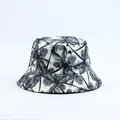Close-up of stylish bucket hat with black palm tree print on white fabric. - Coconut Tree Print