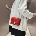 Kleine rode rechthoekige crossbodytas met gouden ketting en gepolijste metalen sluiting. - Rood