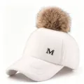 Close-up of white wool baseball cap with a fluffy brown pom-pom and metal M logo - Adult Size (58CM Adjustable) / White Hat with Camel Pom Pom