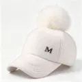 Close-up of white fuzzy wool baseball cap featuring a large pom-pom and metallic M badge - Adult Size (58CM Adjustable) / White