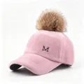 Detailed view of the pink faux fur baseball cap featuring a large pom-pom and metal M logo. - Adult Size (58CM Adjustable) / Pink Hat with Camel Pom Pom