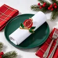Festive pomegranate napkin ring with red crystals on a white napkin and dark green plate - Pomegranate Style (WZW-PNR-1527)