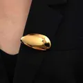 Vintage style smooth polished gold-tone oval brooch pinned on a black blazer lapel - Kc Gold 9203