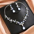 Close-up detail of vintage floral jewelry set with blue stones and sparkling rhinestones - Jelly Blue