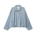 Detail view of an elegant light blue bomber jacket with pleated hem and lapel collar. - Light Blue