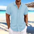 Macro view of blue men's jacquard cotton linen short sleeve shirt with textured pattern - Light Blue