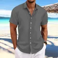 Detail view of men's grey jacquard cotton linen casual shirt on a model at the beach. - Gray