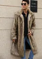 Elegant man wearing a long faux fur coat with square collar standing against a wall - Long Yellow Fur