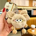 Dettaglio di un portachiavi elfo di peluche beige con fiocco su una chiave dell'auto - Fiocco Cachi