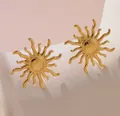 Detailed view of vintage gold sun-shaped stainless steel stud earrings on white stand - Irregular Sunburst Style (128)