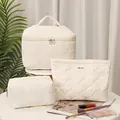 Cream-colored shell-quilted 3-piece makeup bag set for travel and organization. - 3 Piece Set / Set of 3 / Off White