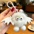 Primo piano di un simpatico portachiavi in peluche di pipistrello bianco con occhi - Diavolo Bianco