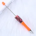Orange DIY beaded ballpoint pen decorated with shiny colorful rhinestones on a white fur - 1.0mm Bullet Tip / Neon Orange