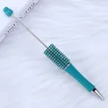 Teal DIY beadable ballpoint pen with rhinestone barrel on plush white background - 1.0mm Bullet Tip / Royal Blue