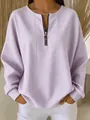 Detailed view of a purple striped women's top featuring a front half-zipper closure. - S / Tops / Purple