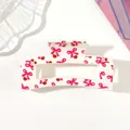 Detailed view of a white hair claw clip with pink bow and cherry pattern print. - Type C White / 8.5cm Size