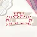 Close-up detail of a white hair claw clip with pink bow and red heart patterns - Style B White / 8.5cm Size