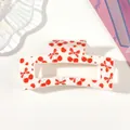 Detailed view of white hair claw clip featuring vibrant red cherry and bow patterns - Type D White / 8.5cm Size