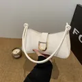 Elegant white underarm bag with gold D-buckle and knotted straps for a chic French style - White