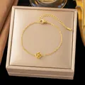 Close-up of gold titanium steel bracelet featuring a delicate rose flower charm - Single Camellia Bracelet (Gold)