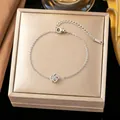Close-up of elegant silver rose flower charm bracelet on a gold jewelry box - Single Camellia Bracelet (Silver)