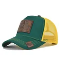 Green and yellow mesh trucker hat featuring a 'DADDY' leather patch and curved brim - Adjustable / Green & Yellow Mesh