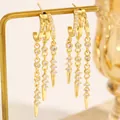 Detailed macro view of gold tassel hoop earrings featuring sparkling zirconia and rivet drops. - 18K Gold Tassel Stud Earrings (15/DZ-164)