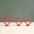 Three sizes of red PE membrane floating display boxes with round bases. - 9x9x2cm / Red