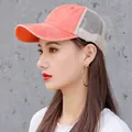 Breathable mesh baseball cap in washed orange cotton shown on a female model - Small Head Circumference (48-54cm) / Orange Red