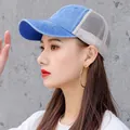 Unisex washed blue denim mesh trucker hat sun cap worn by a stylish female model - Blue